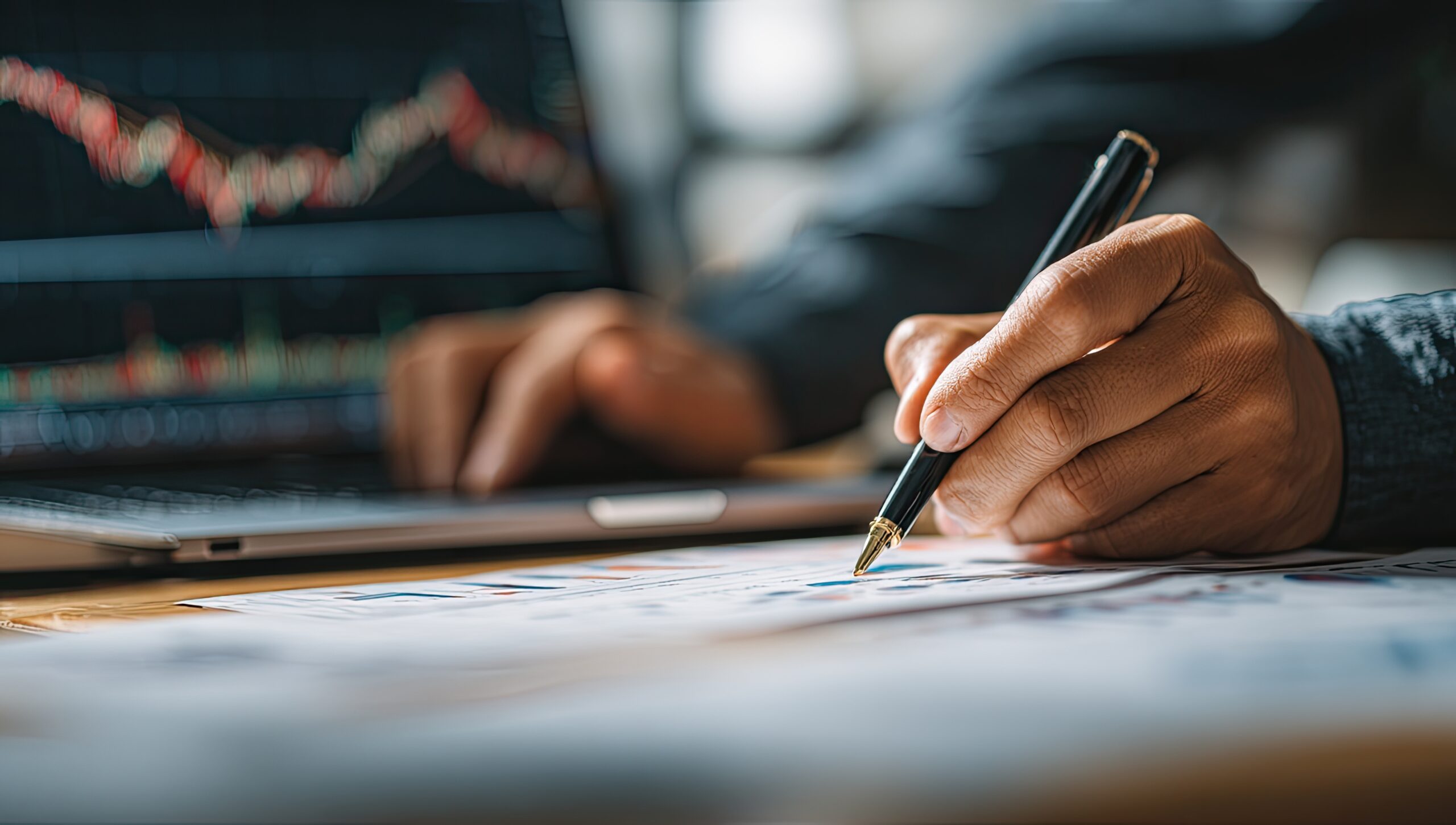 2ï¸âƒ£ businessman analyzing a financial graph and drawing on a laptop on his desk, close-up of hands with a pen working in the office. business concept for layout design, marketing plan, or cargo distribution. fine details, high quality, realistic photo captured by a sony alpha a7 iii at f/2.4. --ar 53:30 --v 7 Job ID: 184547a1-2960-4d59-8c5c-838cd671d0cb